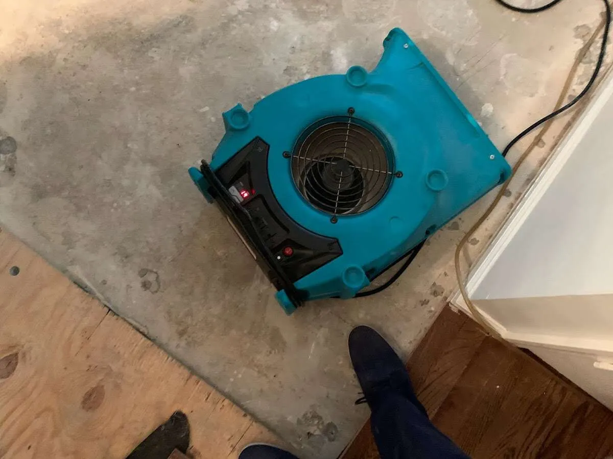 Air mover drying subfloor during Commercial Water Damage Restoration in Berryville
